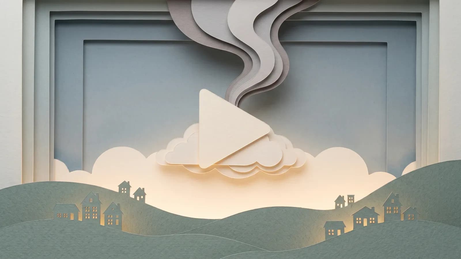 Diorama en papier découpé rétroéclairé, un bouton play sur un nuage au-dessus de collines et des volutes de fumée en papier, illustrant l'empreinte carbone du streaming