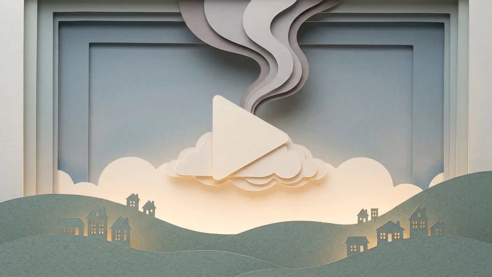 Diorama en papier découpé rétroéclairé, un bouton play sur un nuage au-dessus de collines et des volutes de fumée en papier, illustrant l'empreinte carbone du streaming
